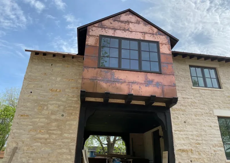 Copper metal panel facade on a stone building for Skylight Installation in Westwood