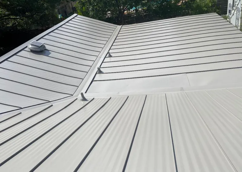 Solar attic fan installed on a metal roof for Roof Ventilation in Westwood